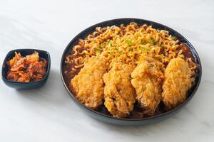Korean instant noodles with fried chicken or Fried chicken ramyeon. photo