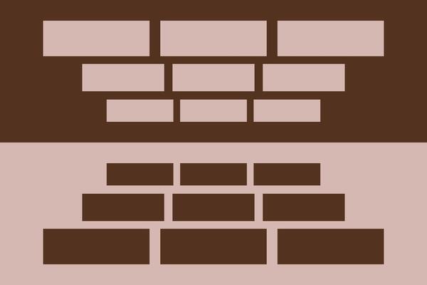 A brick wall with a brick on top of it