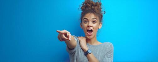 Playful female pointing across screen in bright studio environment photo