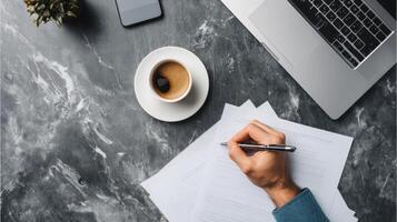 Overhead view of businessman's hand writing on document office professional photo