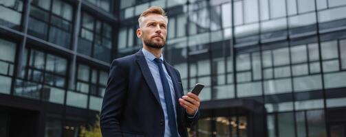 Professional man waiting outside modern office building urban setting photo