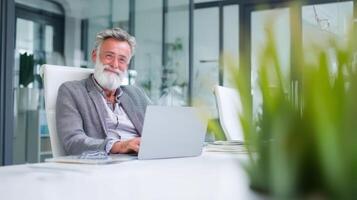 Happy mature businessman working at modern desk in office space photo