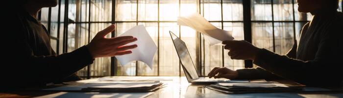 Dynamic hand gesture discussion with laptop and papers in office photo