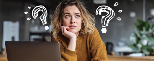 Businesswoman contemplating ideas at laptop modern office thoughtful environment photo