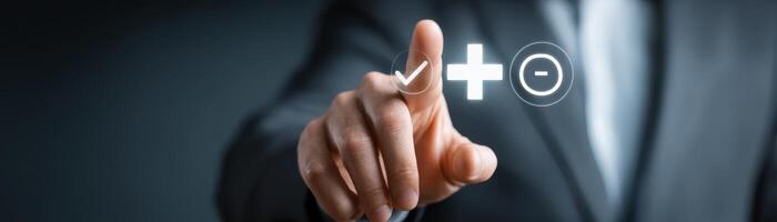 Businessman pointing at plus icon on screen for decision making photo