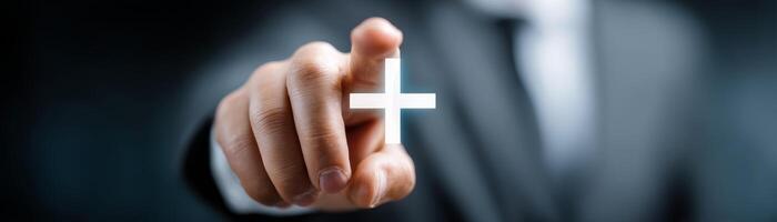 Businessman pointing at plus icon on screen for decision-making photo