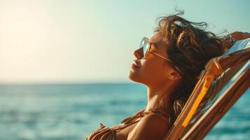 Relaxing beachside woman on deckchair in tranquil setting photo