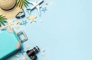 Travel accessories creating a frame on light blue background with copy space photo