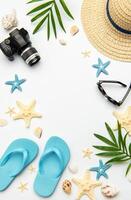 Summer accessories creating a frame on white background with copy space photo