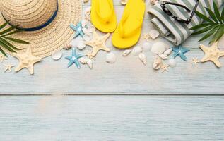 Summer accessories creating a frame on a wooden background with copy space photo