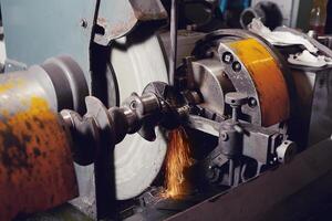 Grinding of the crankshaft on a grinding machine. Car tuning, engine power amplification. photo