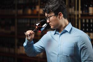 Professional Sommelier Evaluating Red Wine in Cellar Environment photo