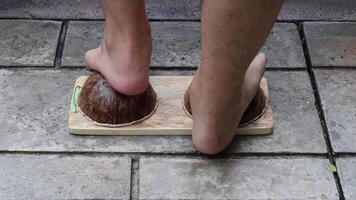 Achilles tendon stretch and manage plantar fasciitis using coconut shells through foot massage, principles of folk wisdom. video