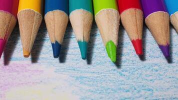 Vibrant Colored Pencils Lined Up on Sketch Paper in Creative Office Setting video