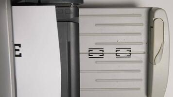 Close-up of a printer delivering a stark termination notice in a simple office environment video
