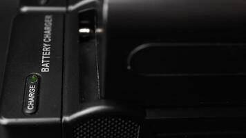 Close-Up View of Modern Battery Charger with Green Charge Indicator Light in Indoor Setting video