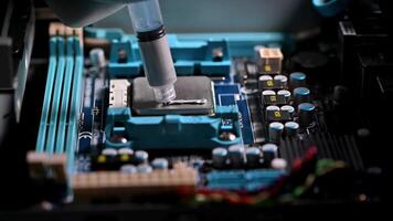 Precision Application of Thermal Paste on a Computer CPU in a High-Tech Repair Environment video