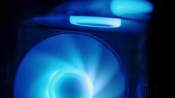 Vibrant RGB LED illuminated PC case fan spinning inside a sleek gaming desktop setup with dynamic lighting effects video