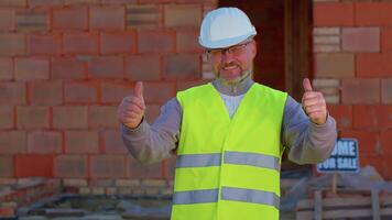 Civil engineer architect specialist raises thumbs up agrees with something or gives positive reply recommends advertisement likes good at construction site. Developer builder. Real estate home project video