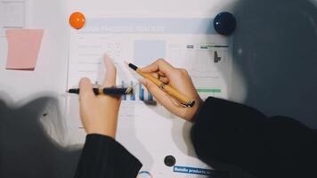 A person is pointing to a whiteboard with a pen video