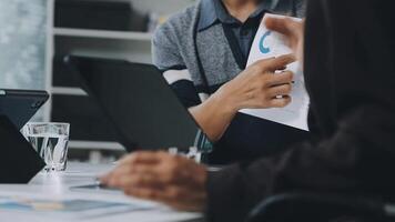 A man is holding a piece of paper while sitting at a table video