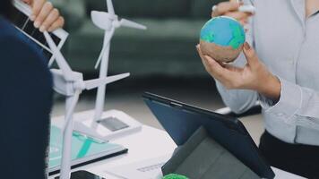 A man holding a globe and a laptop computer video