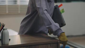 A person in a rubber glove is holding a clipboard video