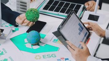 People working on a laptop with a green egg on it video
