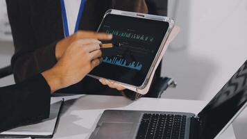 A business person using a tablet to show graphs video