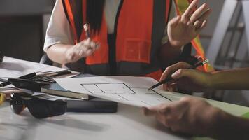 A man and woman working on construction plans video