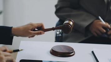 A judge's gavel is being held by a man's hand video