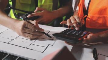 Two people working on a construction project with a calculator video