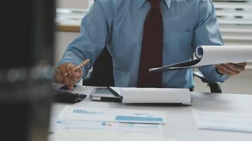 A man in a tie is working on paperwork video
