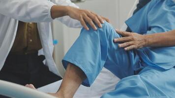 A doctor is helping an elderly man in a hospital bed video