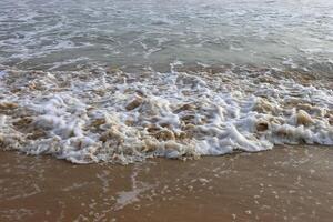 ocean waves crashing on shore during daytime photo