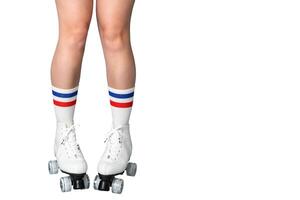 Female caucasian legs in roller skates and striped socks on white background photo