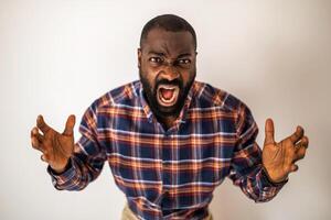 Portrait of emotionally stressed and angry black man who is shouting. photo