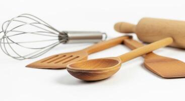 Wooden Cooking Utensils Spoon, Spatula, Rolling Pin, and Whisk on White Background photo