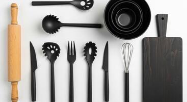 Minimalist kitchenware arrangement Black utensils, wooden rolling pin, and bowls on white background photo