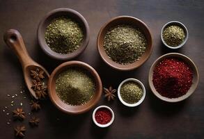 Various spices and herbs in bowls on a wooden table photo