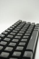 A mechanical keyboard with a 61 layout in black from the top with a white background photo