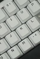 The keycaps of a white mechanical keyboard with a monochrome theme that looks clean photo
