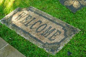 Welcome sign on a stepping stone in a park photo
