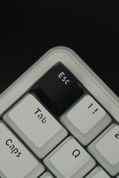 Black escape key on a mechanical keyboard in close up mode with monochrome theme with black background photo