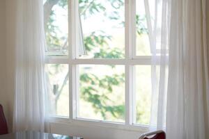 Minimalist white box shaped window with curtains open photo