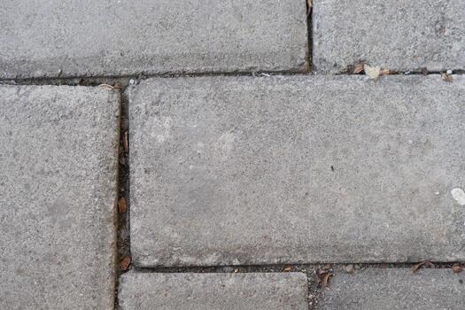 Background of grey paving blocks with lines on it photo