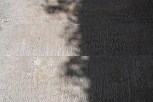 Shadows of tree leaves on a cement staircase during the day photo