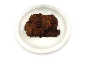 Flavourful and juicy beef chappal kebab in a white plate beautifully isolated on the white background photo