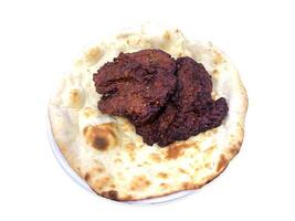 Tasty beef kebabs with naan in a white plate isolated on white photo