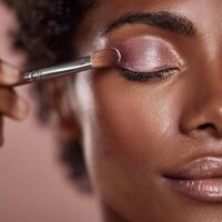 Woman applies makeup. portrait. photo